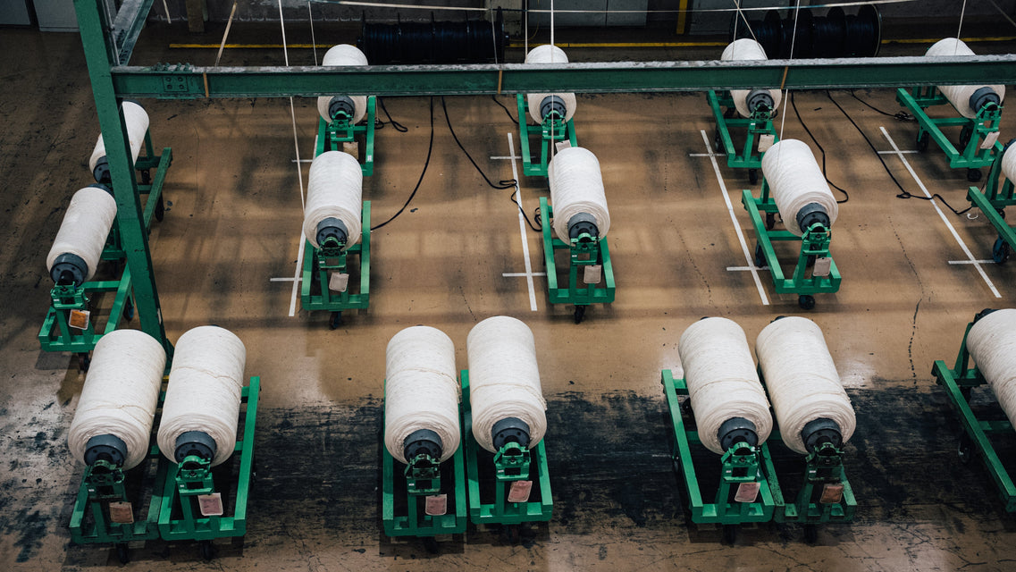 Textile production line with spools of thread in a factory setting